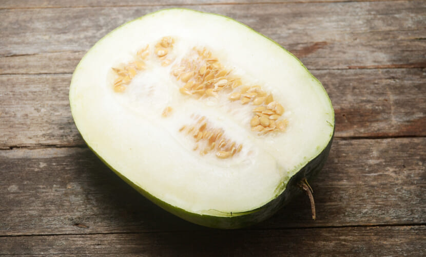 Winter,Melon,Half,Slice,On,Rustic,Wood,Table
